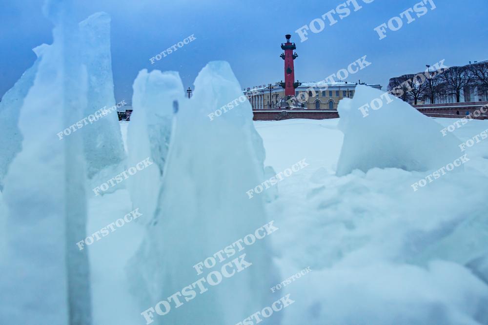 Фотография зимнего Санкт-Петербурга с видом на Васильевский остров и Стрелку, где река Нева впадает в Финский залив. На снимке запечатлены заснеженные улицы, набережные и историческая архитектура центрального района города. Зимний свет подчеркивает белизну снега и контраст архитектуры на фоне воды, создавая атмосферу спокойствия и романтики северной столицы России. Панорамный ракурс позволяет увидеть масштаб города, красоту водных пространств и гармоничное сочетание природы с городской инфраструктурой. Изображение идеально подходит для туристических публикаций, зимних коллекций фотографий, постеров и интерьерного оформления.